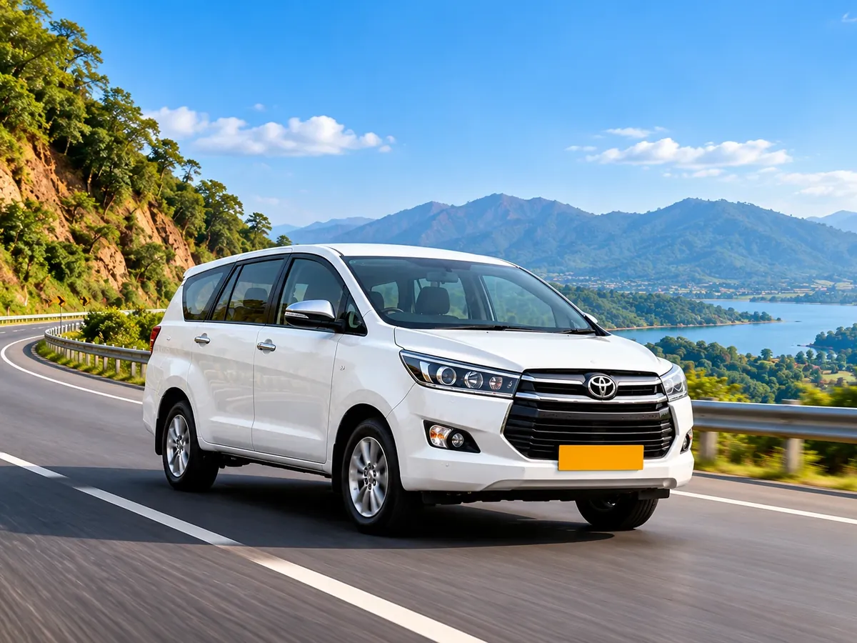 White Innova on a scenic hill highway during an outstation trip